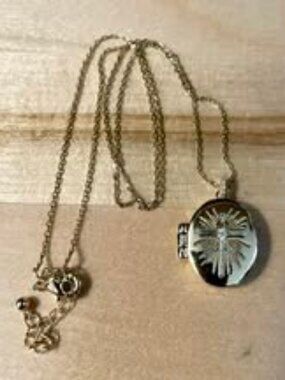 Gold locket with cross engraving